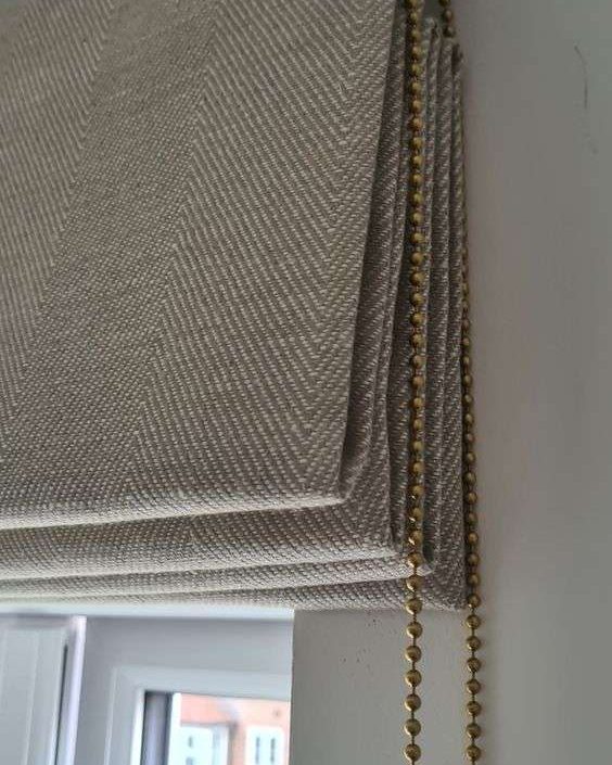 Cream roman blind with soft folds in a Dubai home