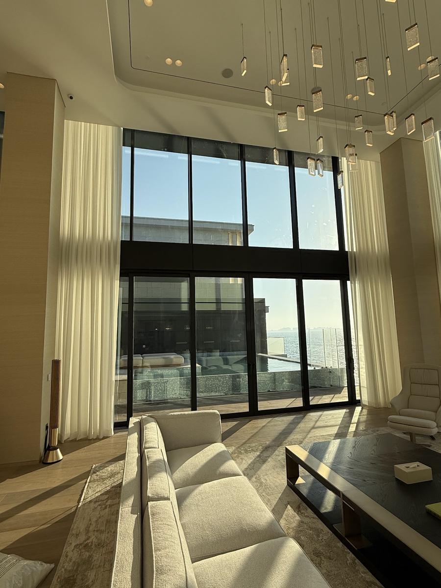 White sheer curtains diffusing daylight in a Dubai apartment with a sea view