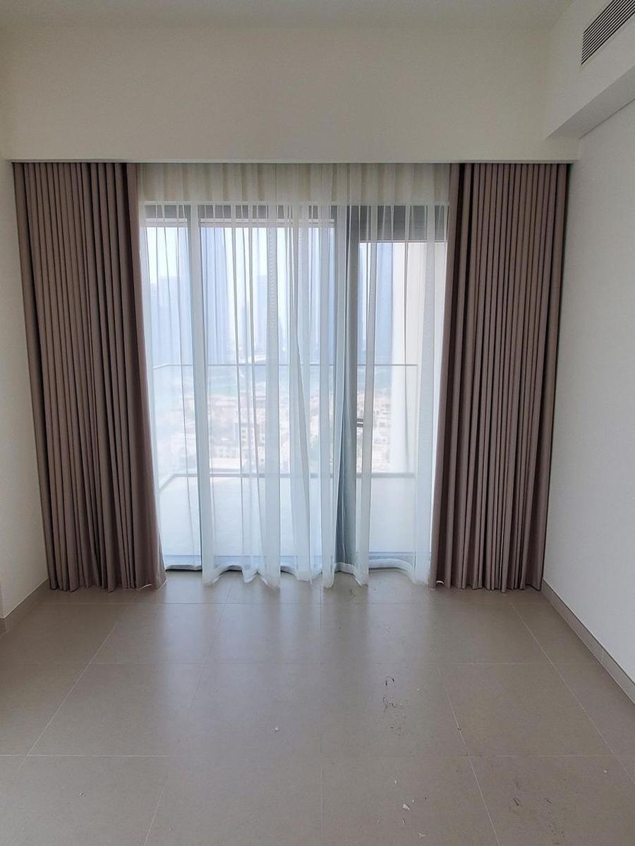 Grey wave curtains with even S-folds in an elegant UAE bedroom