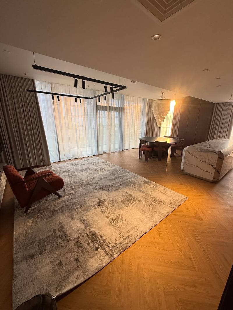Floor-to-ceiling sheer and blackout curtains in a Bluewaters Residences living room