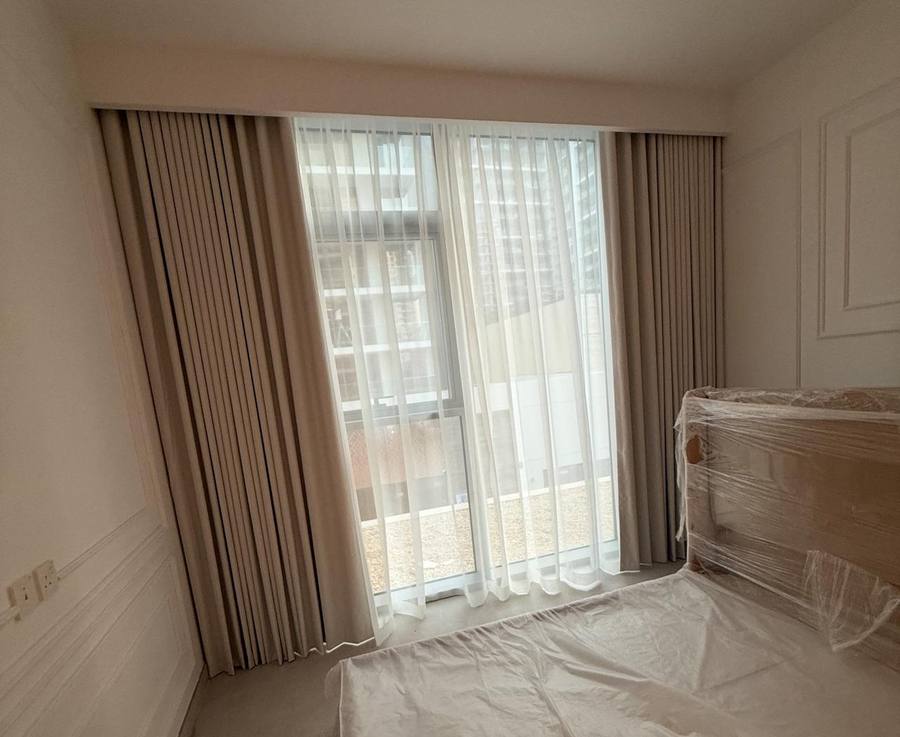 Cream layered curtains in a master bedroom at Ellington House, Dubai Hills Estate