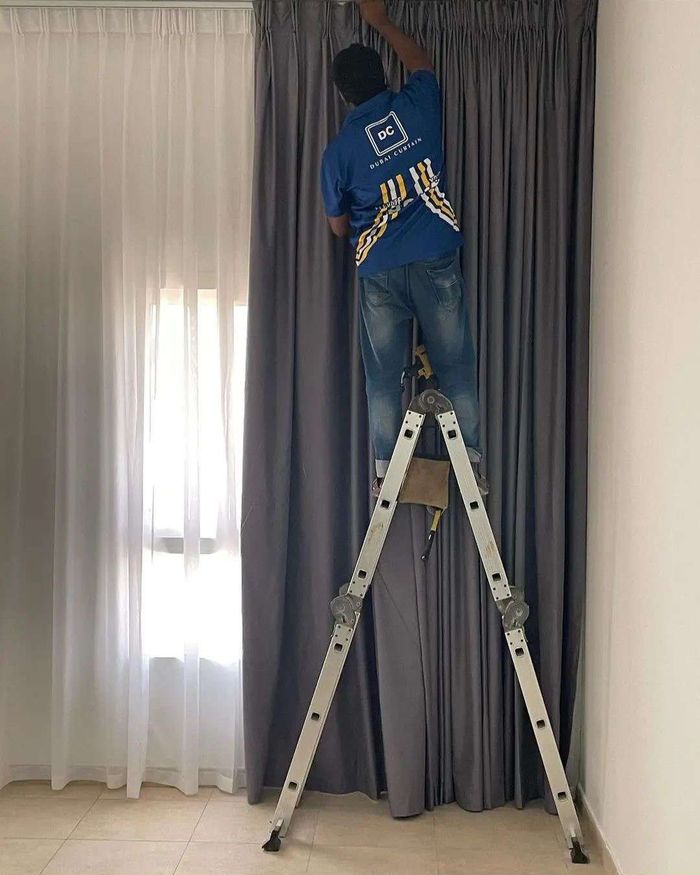 Dubai Curtain technician installing curtains at a customer's home