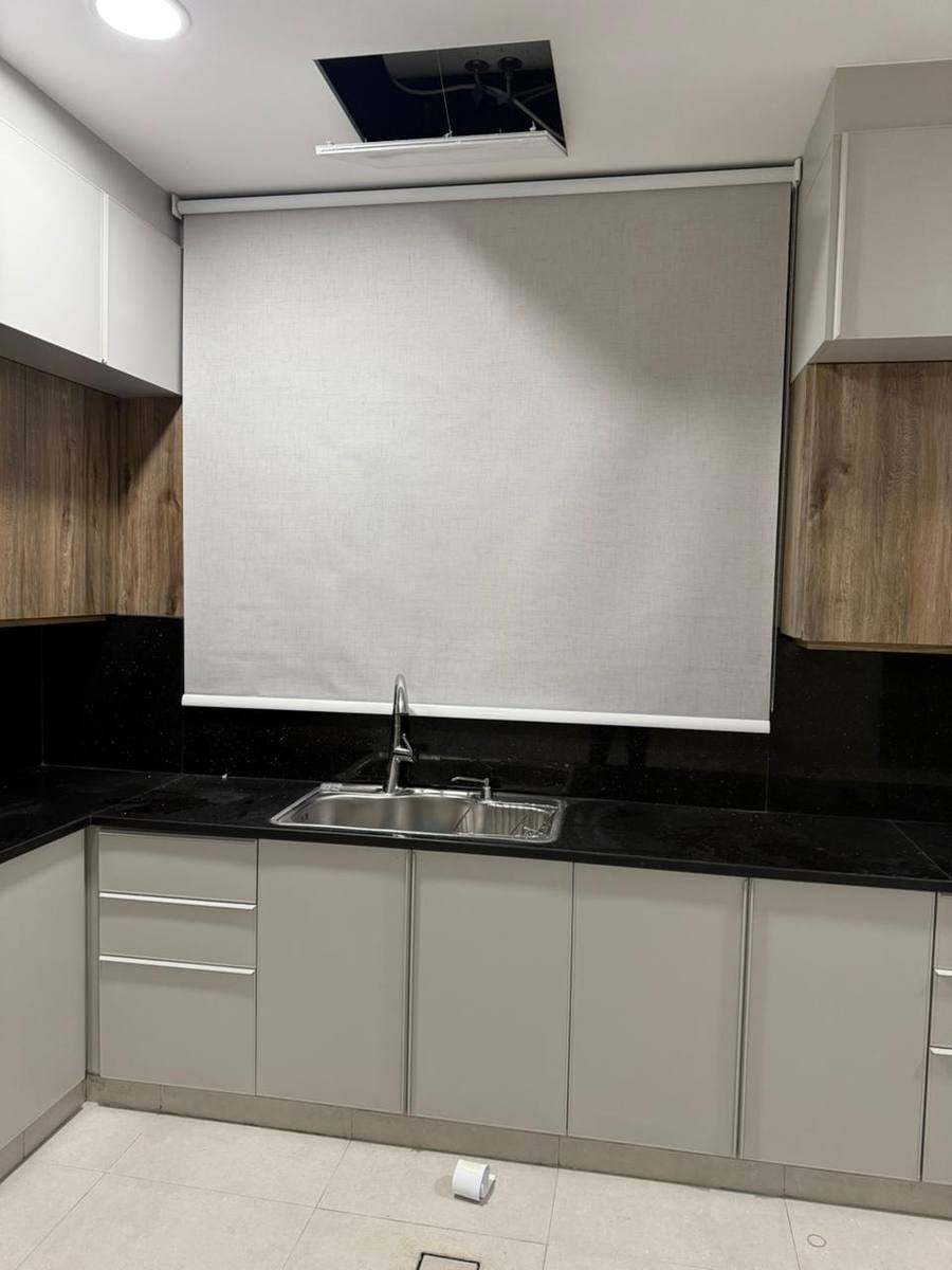 White roller blind in a modern grey kitchen