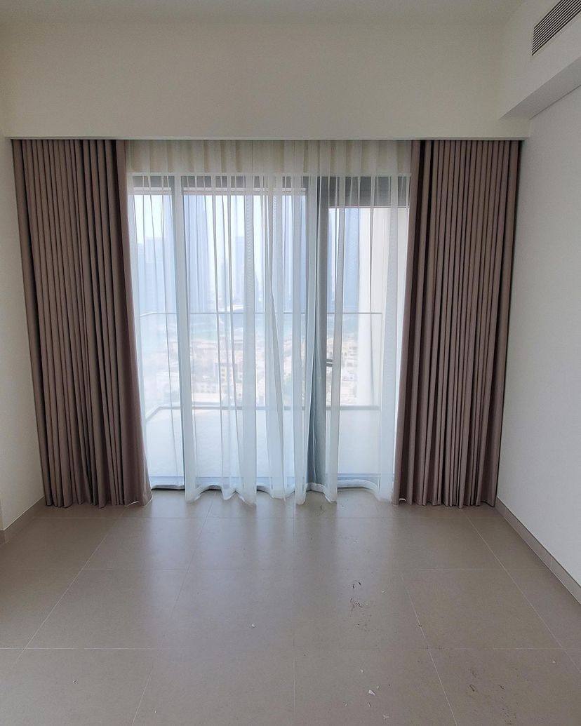 Taupe curtains and sheers installed in a newly handed-over apartment