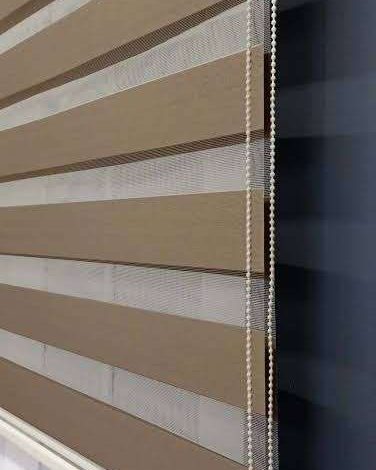 Close-up of beige zebra blind fabric bands